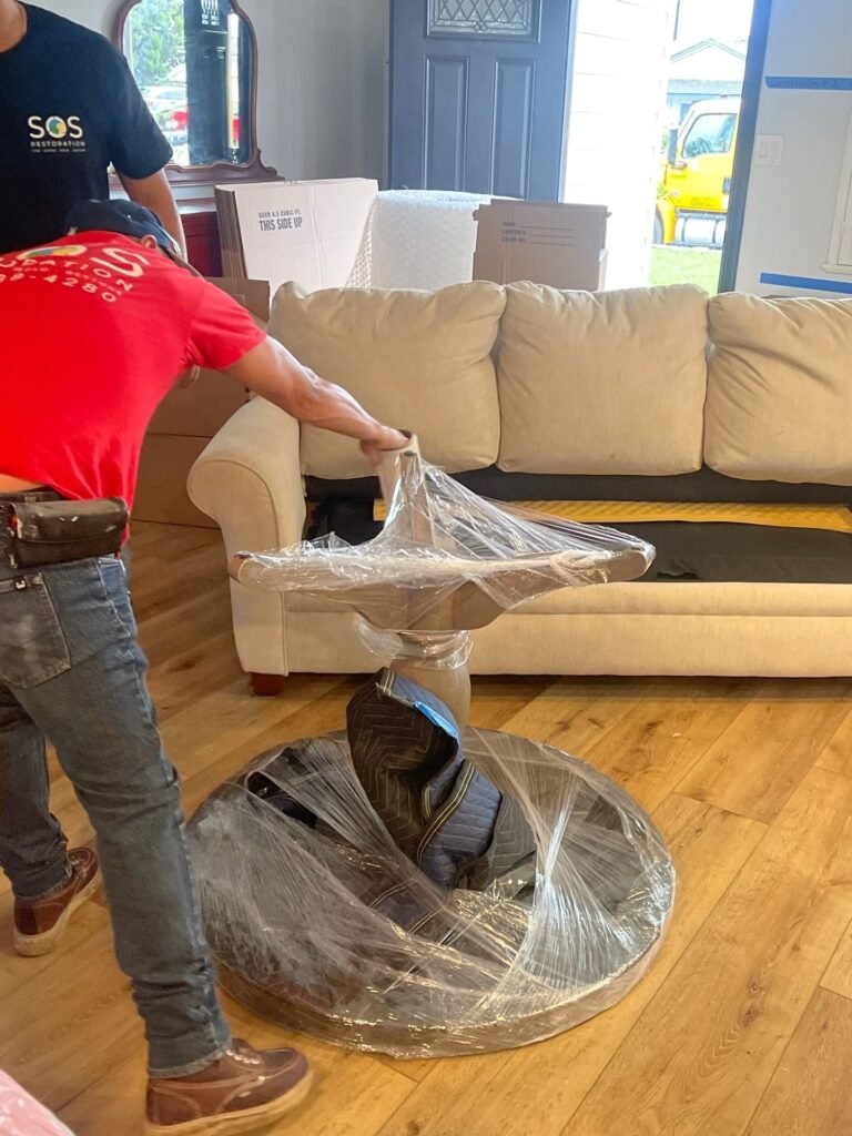 Wrapped demolition debris carried out of a Ventura County living room