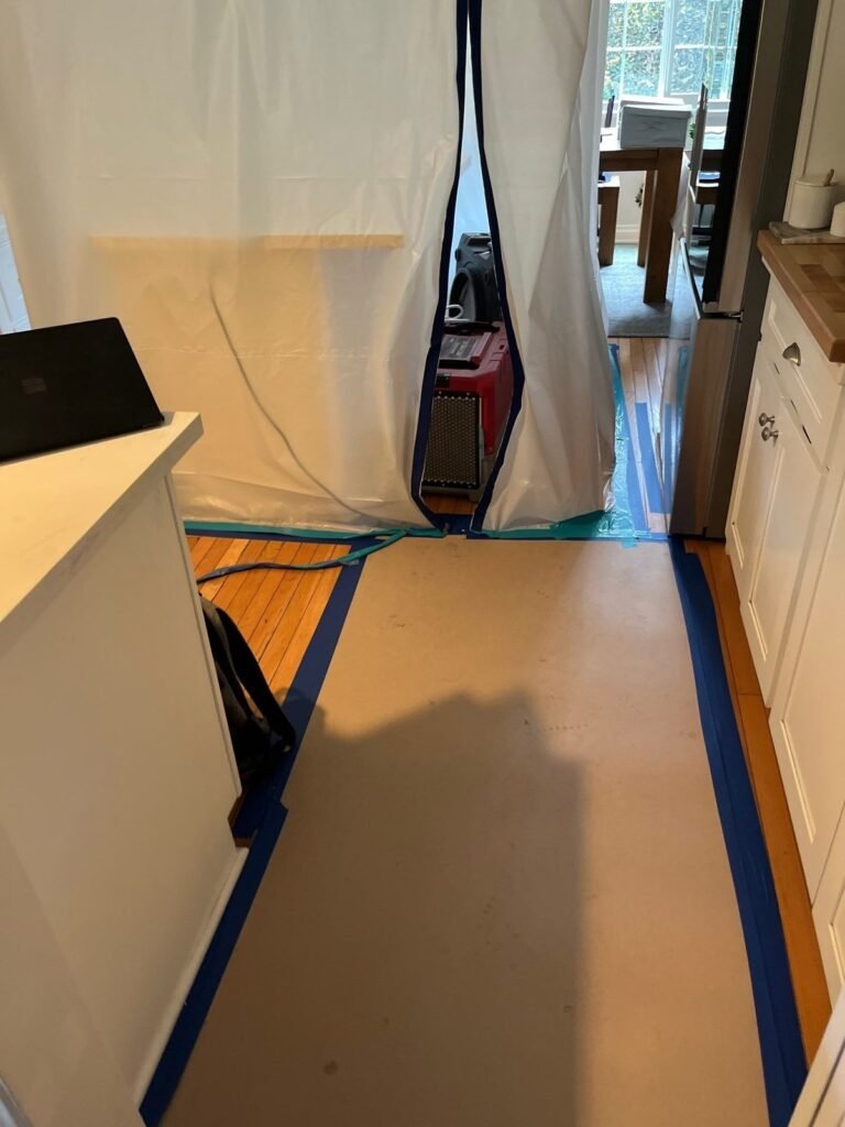 A zippered containment barrier closing the way through to a dining room