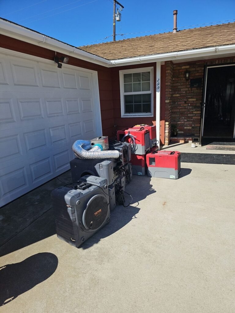 Drying equipment staged on the driveway in front of a garage door in Ventura County