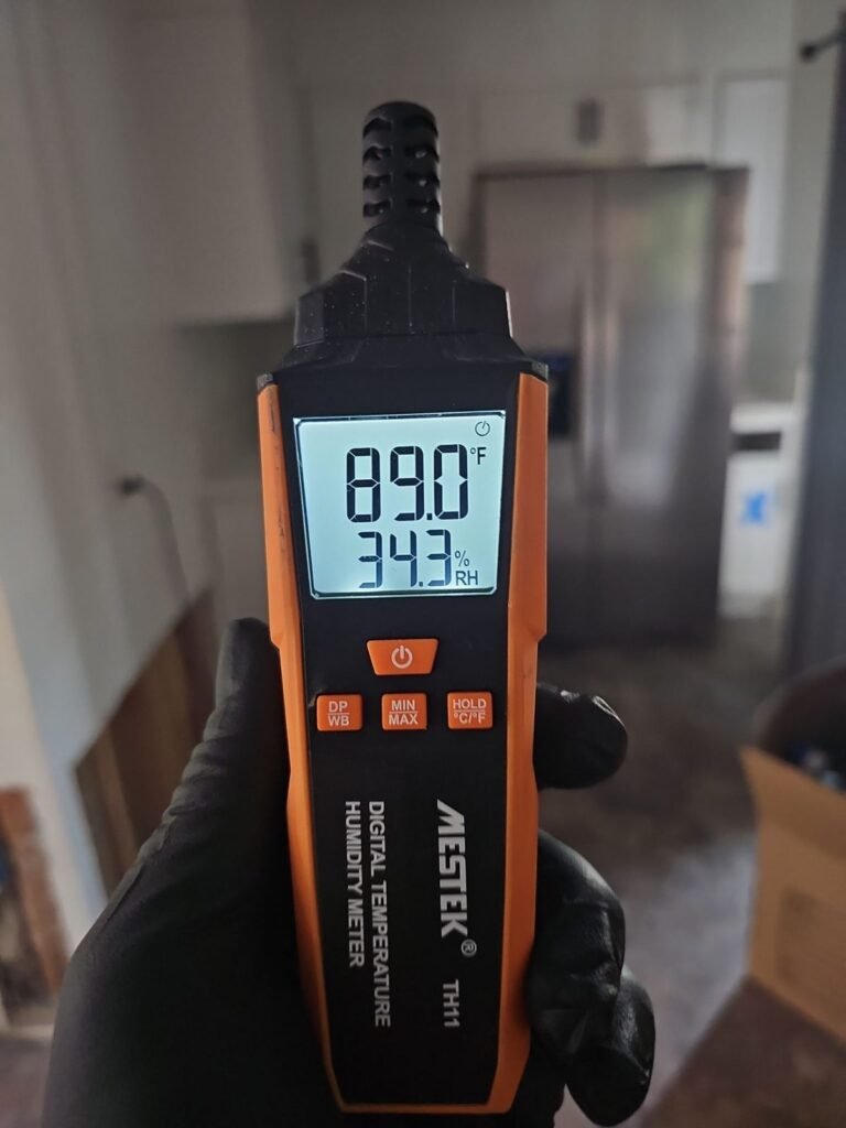 A humidity meter reading 89.0 degrees inside the house